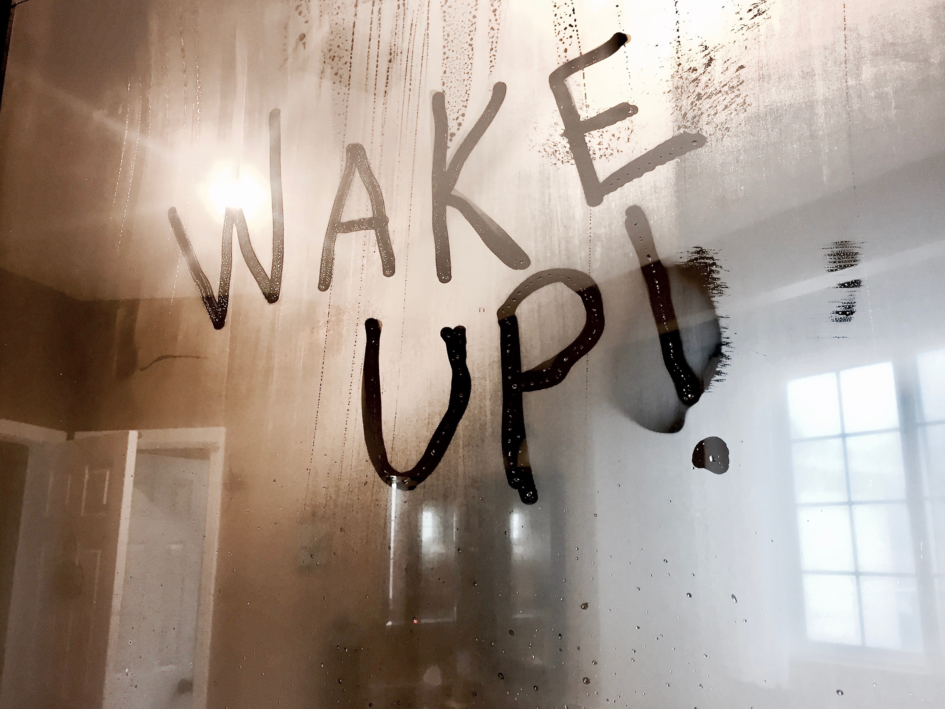 Photo of the words "Wake Up!" written on a bathroom mirror.